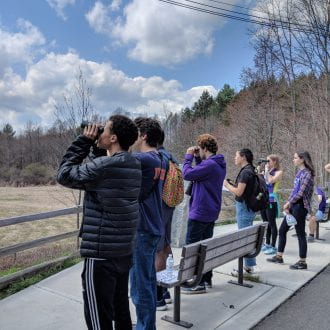 students looking at field